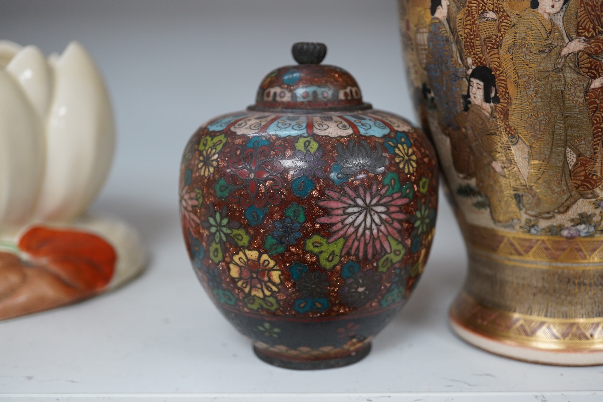 A pair of Japanese cloisonné enamel jars and covers, a Japanese bronze and gold overlaid small vase and a Satsuma pottery vase, tallest 22cm high (4). Condition - finial loose and one missing on cloisonné jars and covers